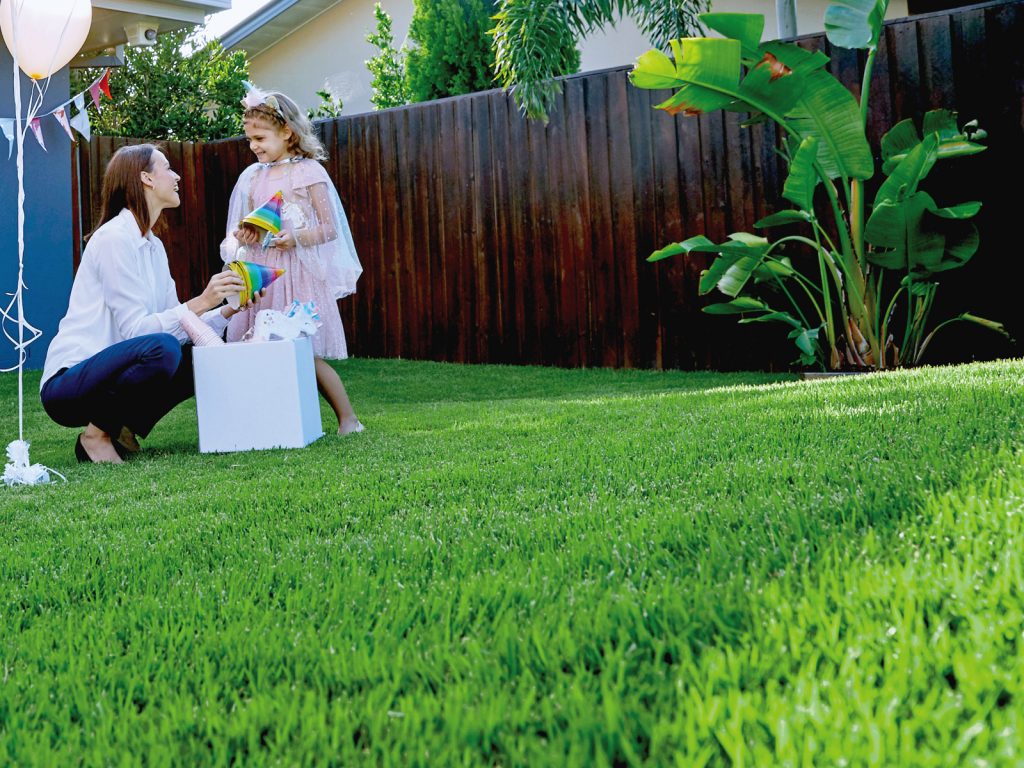 Family Celebrating Birthday Party on Lush Green Zoysia Turf