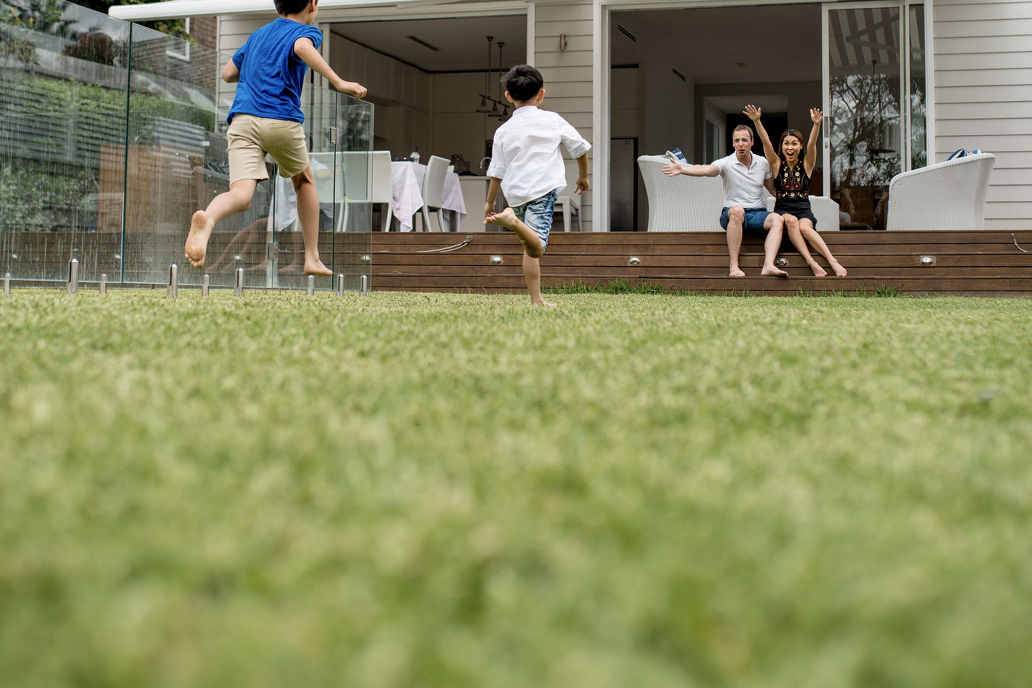 Kids running barefoot in the backyard.