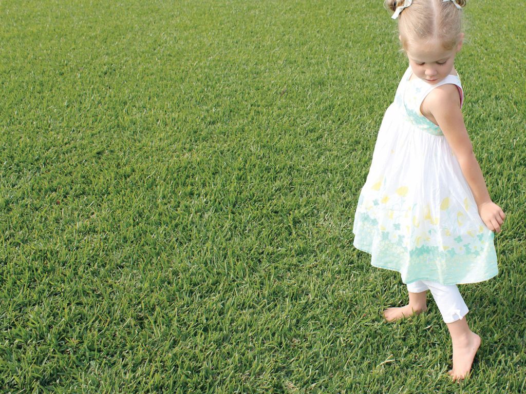Young Girl Playing on Buffalo Lawn