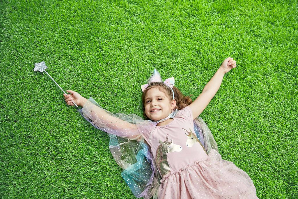 Girl Lying on Top of Soft Empire Zoysia Lawn