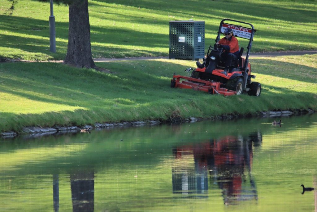 ride on lawn mower next to lake