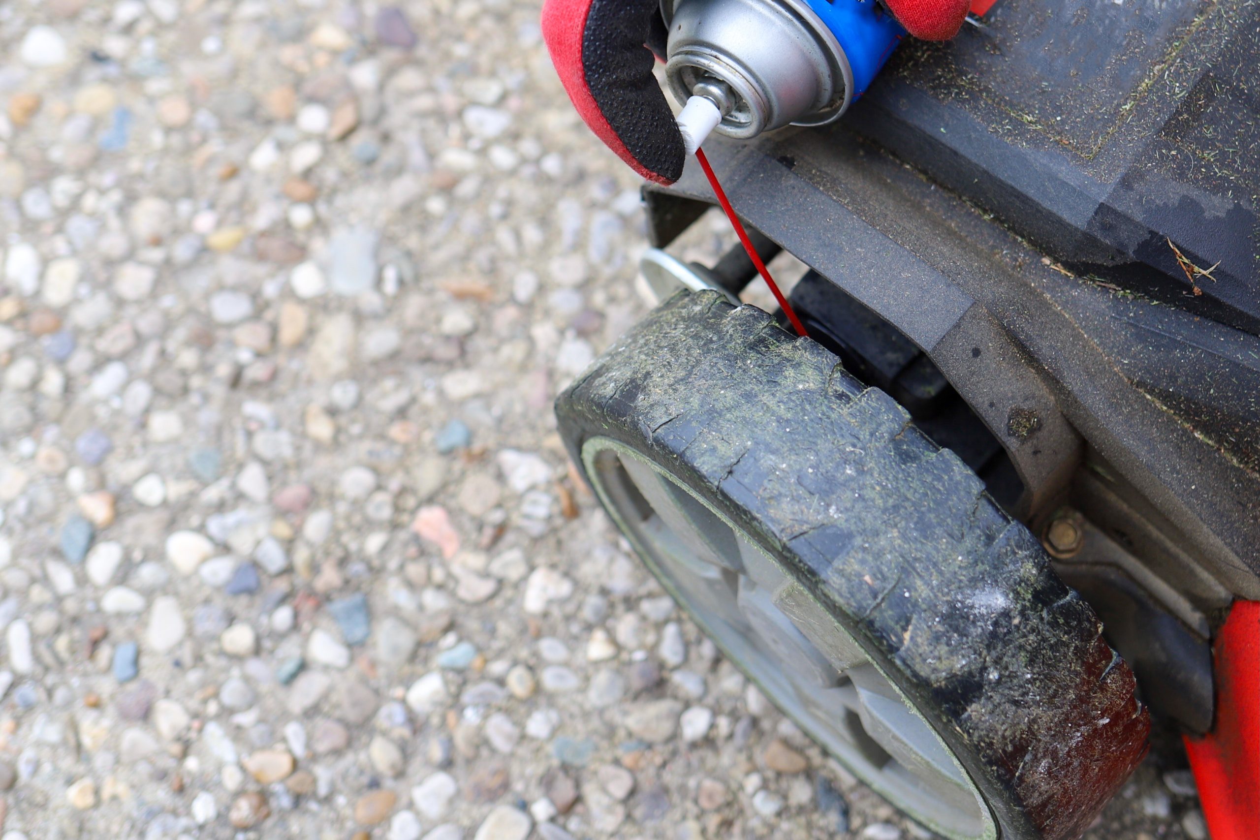 Spraying lubricant on mower wheels